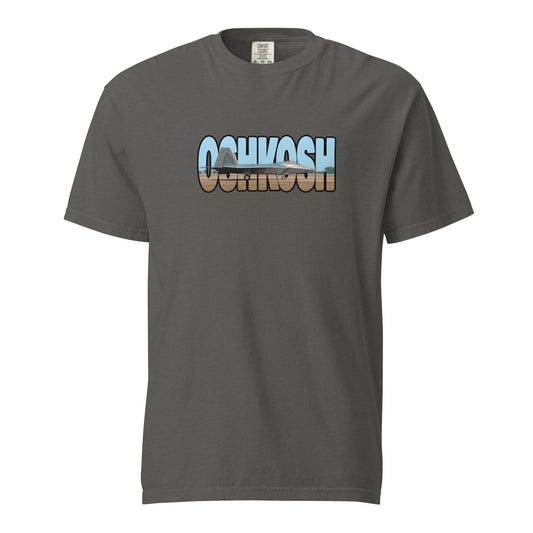 This shirt features an image of an F-22 taxiing at Wittman Regional Airport contained inside of the word "Oshkosh"